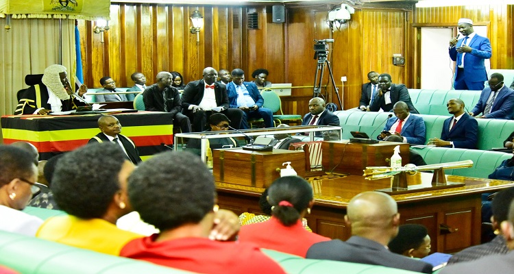 Ssemujju Nganda (standing) praised Oulanyah for his spirit of reconciliation